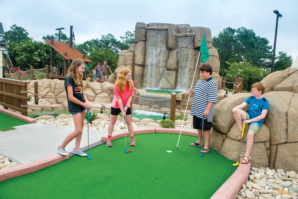 Kids play mini golf at Pirates Island at Corolla Light Town Center